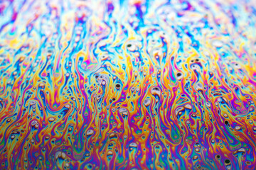 Beautiful psychedelic abstraction formed by light on the surface of a soap bubble