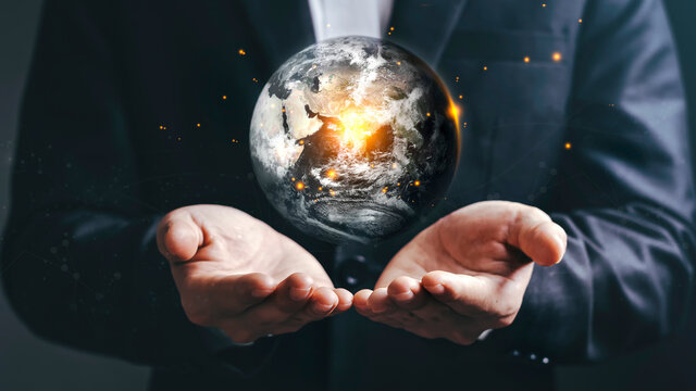 Businessmen and the Earth in Global Warming Earth day, Elements of this image furnished by NASA