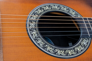Selective focus  of acoustic six string guitar sound hole and Phosphor bronze strings