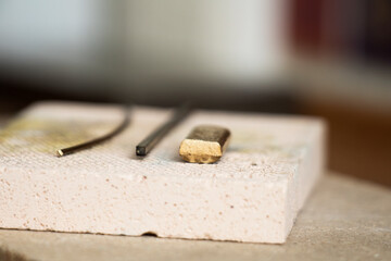 Goldsmiths tools on the jewelry workplace. Tools over rustic wooden background.