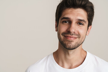 Fototapeta premium Portrait of joyful young man smiling and looking at camera