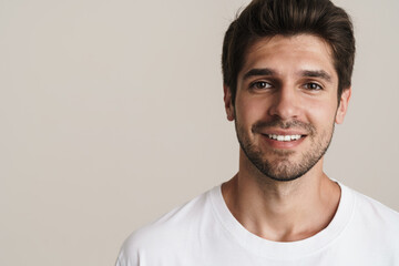 Fototapeta premium Portrait of joyful young man smiling and looking at camera