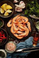 Fresh and raw big shrimps ready to be prepared. With various ingredients on side