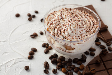 Cocoa mousse dessert in plastic transparent box on grey surface