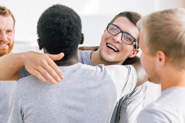 two happy student friends hugging each other