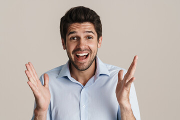 Portrait of excited handsome man expressing surprise on camera
