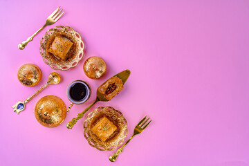 Fototapeta na wymiar Cup of coffee and turkish dessert baklava on pink