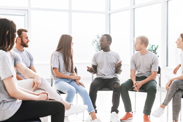 handsome guy telling his ideas to a group of like-minded people.