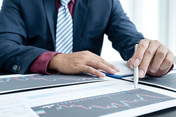 Hand of businessmen are planning business investments related to shares By analyzing and...