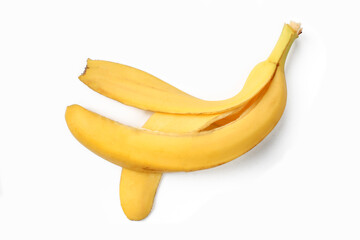 Yellow banana skin isolated on white background. Slippery eaten banana peel