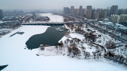 Fototapeta na wymiar Snowscape of waterfront city, aerial photo