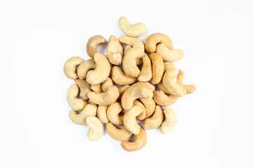 Pile of delicious brown Cashew nuts isolated on white background.