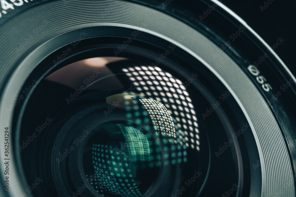 Poster Close up beautiful camera aperture lens with multi colored light glass reflection. Macro view.