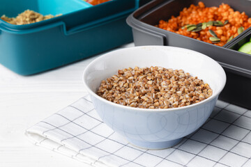 Lunch box with cooked buckwheat and fresh vegetable salad