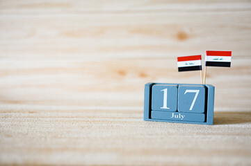July 17 Wooden calendar and Iraq Flag Concept Iraq national day