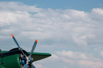 blue green airplane propeller close-up on blue sky background
