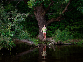girl by the old oak tree by the lake