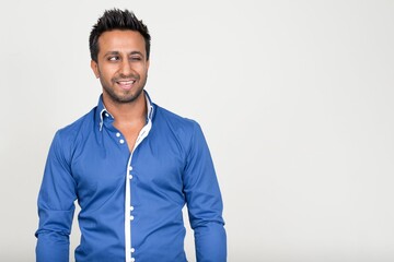 Portrait of happy bearded Indian businessman winking