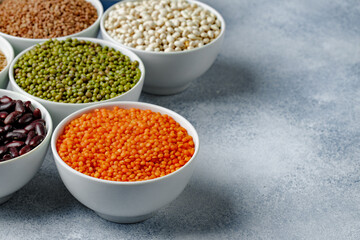 White ceramic bowls with assorted grains on kitchen table