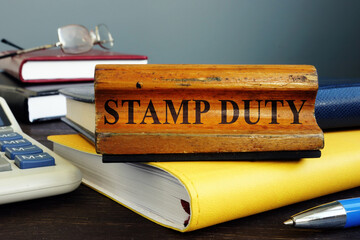 Stamp duty sign and office supply with business papers.