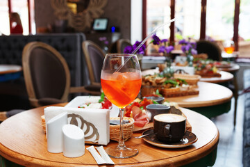 Spritz cocktail and various Italian food, toned