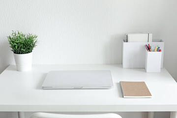 Workspace with white table and laptop, minimalism workplace interior, nobody