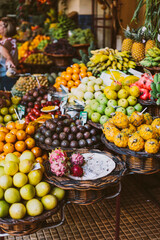 Funchal, Portugal - 20,09.2019. Fresh tropical fruits in wicker baskets. Vertical photo. Madeira's famous market
