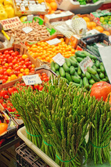 Fresh asparagus and another vegetables on farm market, toned