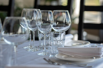 Empty glasses in restaurant background. Table set for an event party or wedding reception.