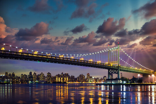 Historic Triborough Bridge from Astoria Queens towards New York City Manhattan after sunset with city lights