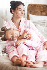 Fototapeta na wymiar Mother and daughter sleeping. Cute child in pajamas