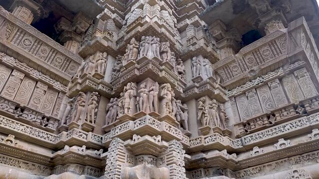 Beautiful Stone Carvings In Khajuraho Temple, UNESCO World Heritage Site In Madhya Pradesh, India. - pan up