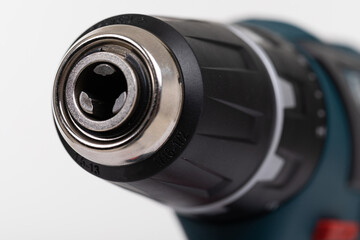 close-up electric drill without drill on an isolated white background