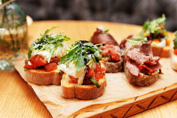 Bruschettas with beef, tomatoes and cheese, toned