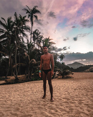 man walking on the beach at sunset