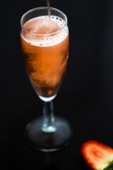 A glass of rose wine with strawberries