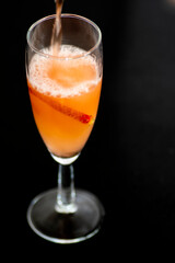 A glass of rose wine with strawberries