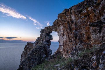 Stone arch in the rock on the shore of Lake Baikal