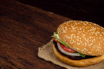 Hamburger meat and vegetables on wooden background