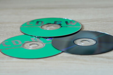 CDs lying on a yellow table