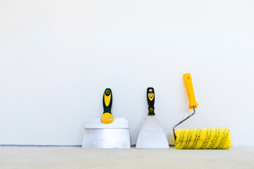 Tools painter-plasterer. Putty and paint the walls. Plasterer tools on a white background.