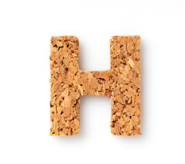 The letter “H" on the cork on a white background