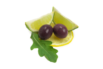 Two olives, piece of lemon and leaves of arugula isolated on white