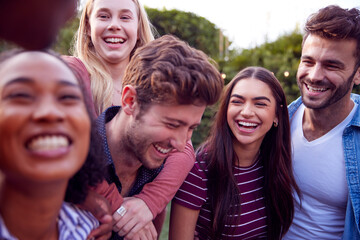 Group Of Multi-Cultural Friends Enjoying Outdoor Summer Garden Party