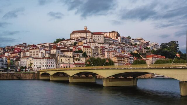 Coimbra, Portugal, zoom out timelapse view of the former Portuguese capital including historical landmark University of Coimbra and Santa Clara bridge over the Mondego River.