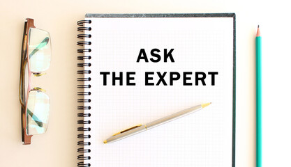 Notepad with text on a white background, near glasses and pencil. Business concept.