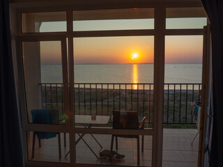 sea view from a hotel room with two chairs and a table