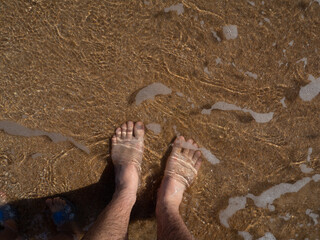 feet on the beach underwater
