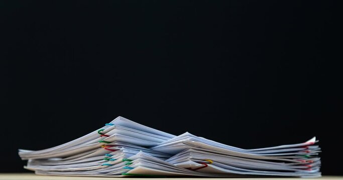 4K Stop of motion stack overload document report paper with paperclip place increase, business and education concept footage paperless used. 