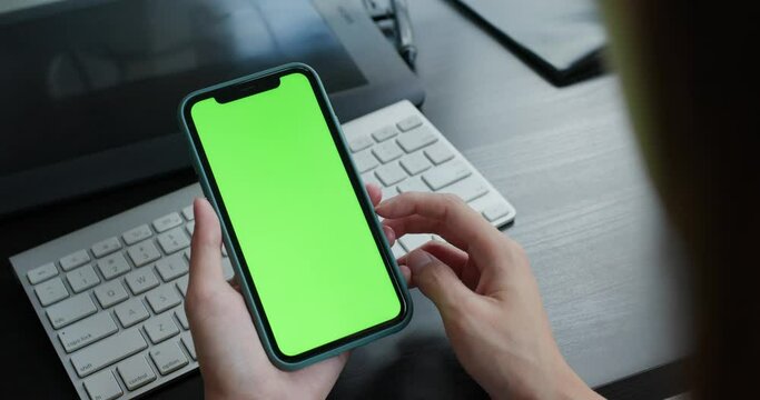 Woman hold cellphone with chroma key